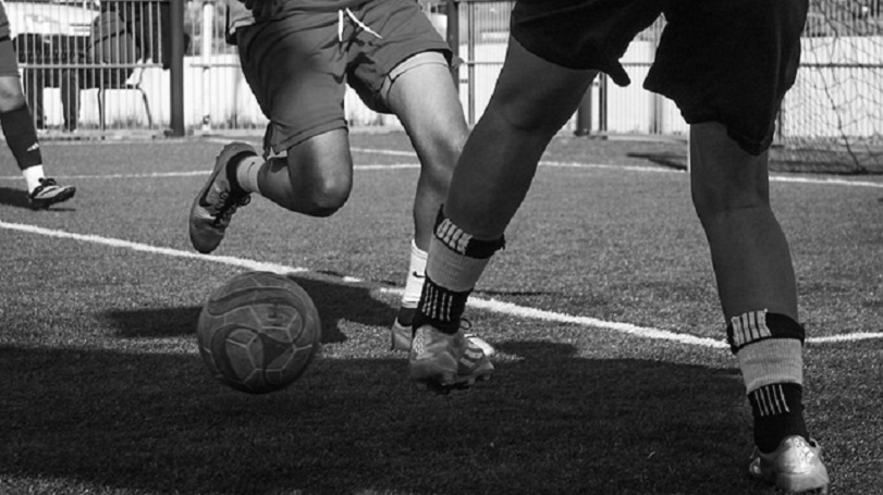 foto in bianco e nero di ragazze che giocano a calcio